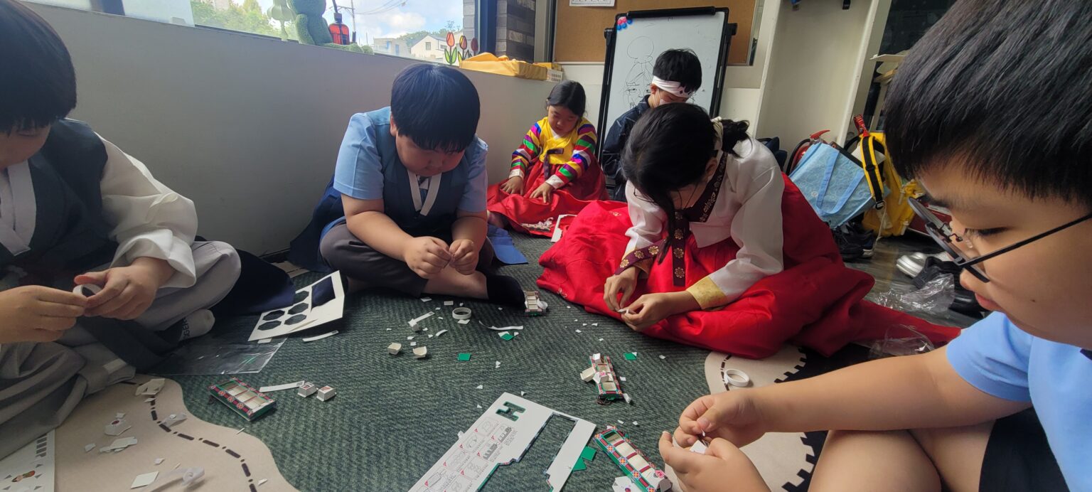 Students building cardboard clickers