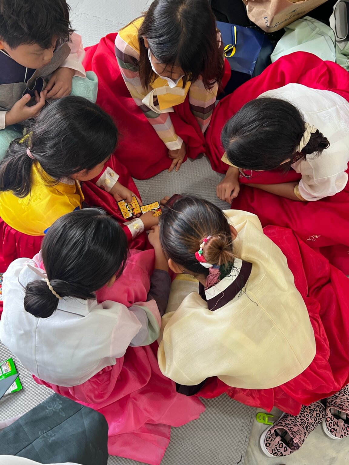 Students in hanbok working together on a craft